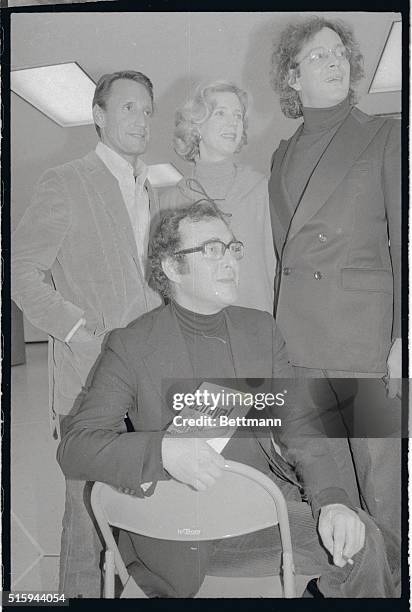 Playwright Harold Pinter seated in front of Roy Scheider, Blythe Danner and Raul Julia. Pinter is holding a copy of Betrayal.