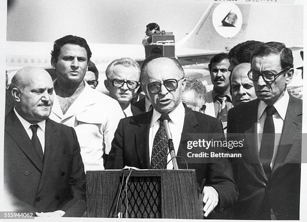 Flanked by Egyptian Foreign Minister Kemal Hassan Ali, Israeli Prime Minister Menachen Begin gives a speech upon his arrival in Cairo for the funeral...