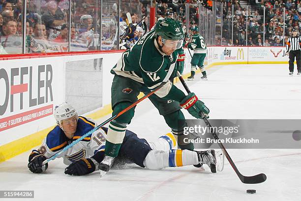 David Jones of the Minnesota Wild handles the puck with Jay Bouwmeester of the St. Louis Blues defending during the game on March 6, 2016 at Xcel...