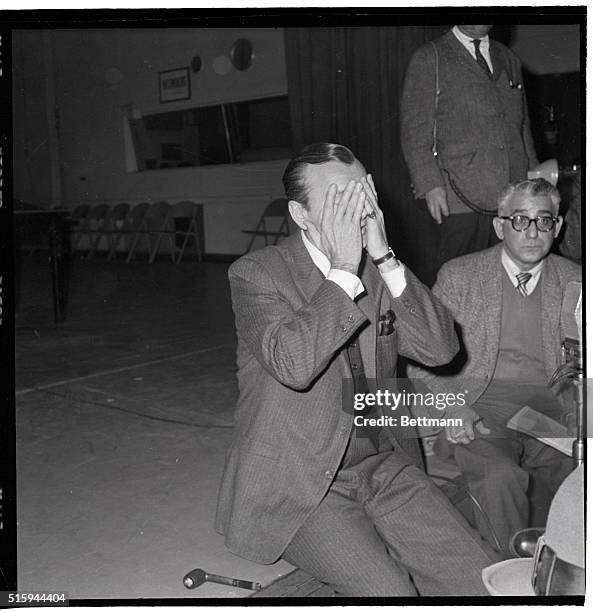 Jack Paar covers his face with his hands on February 13 during a news conference, after walking off his show on NBC-TV. The conference was a surprise...