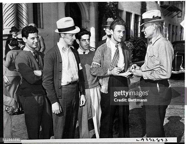 Film technicians gather at Paramount Studios on May 7 where they are striking. J. Stepp, the picket captain, hands out 60 cents to each striker,...