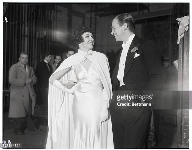 Claudette Colbert and Douglas Fairbanks, Jr., stand together at the Shrine Auditorium in Los Angeles on December 19, 1932. They are attending the...