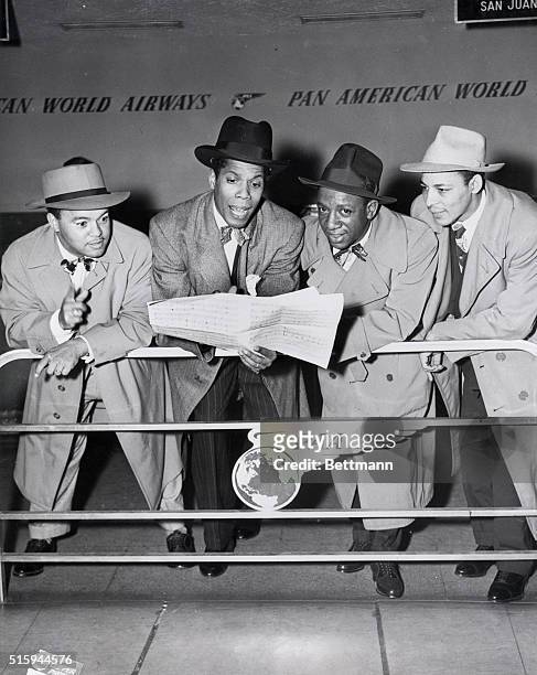 The four Ink Spots give out with a beat on arrival at LaGuardia Field. They had been appearing in London, England, for six weeks. Left to right:...