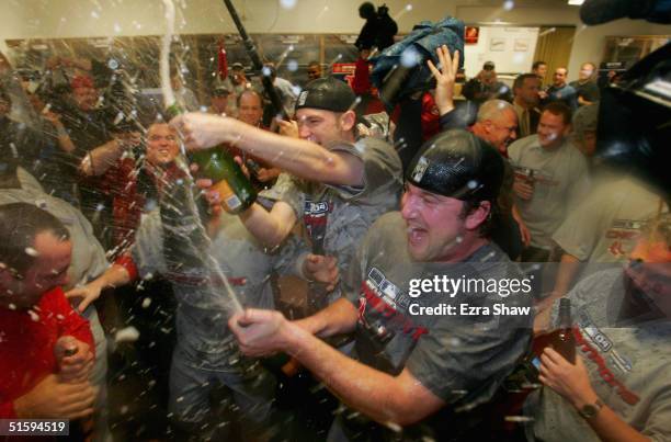 Pitchers Derek Lowe and Bronson Arroyo of the Boston Red Sox celebrate in the locker room after defeating the St. Louis Cardinals 3-0 to win game...