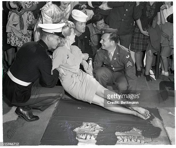 Hollywood, CA: A soldier, a sailor, and a marine found it quite pleasing to cooperate with blonde Betty Grable when her curvaceous legs- credited as...