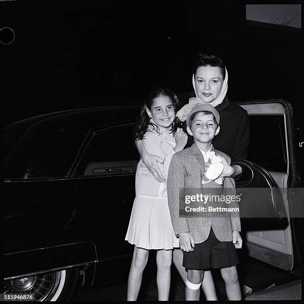 New York, NY: Judy Garland with two of her children, Joe and Lorna before departure to Idlewild Airport.