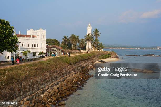fort wall, lighthouse, church and indian ocean. - galle fort stock pictures, royalty-free photos & images
