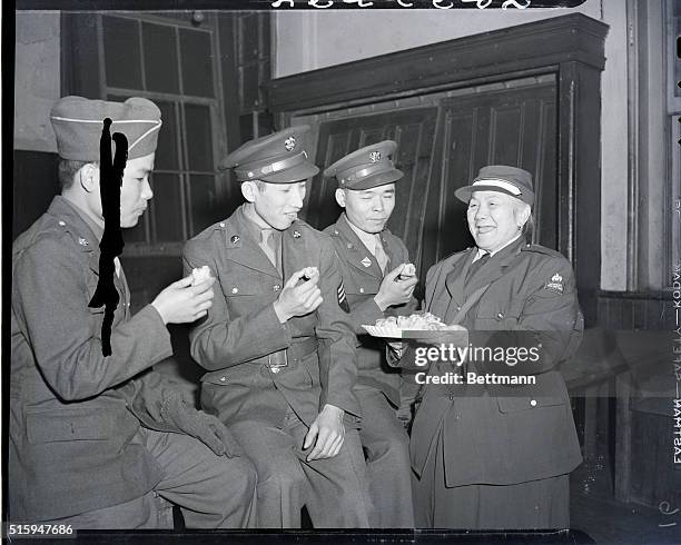 New York, NY: Mrs. Low is shown serving traditional Chinese delicacies to Sergeant Fred Gee , Sergeant Jew G. Jok, 2 Chinese American-U.S. Soldiers...