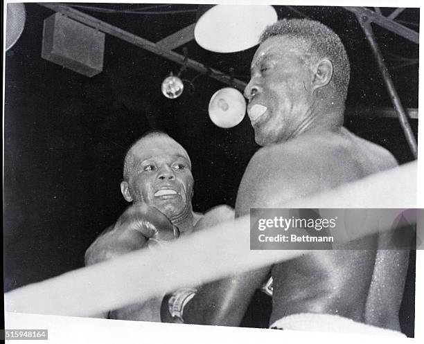 Philadelphia, PA: Belying his 38 years, Jersey Joe Walcott of Camden, NJ, scores with a vicious left to the chin of Ezzard Charles of Cincinnati in...