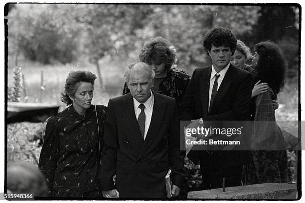 The family of Richard Burton leaves the small church where his funeral was held. In front is widow Sally Burton, with Brook Williams. She is followed...