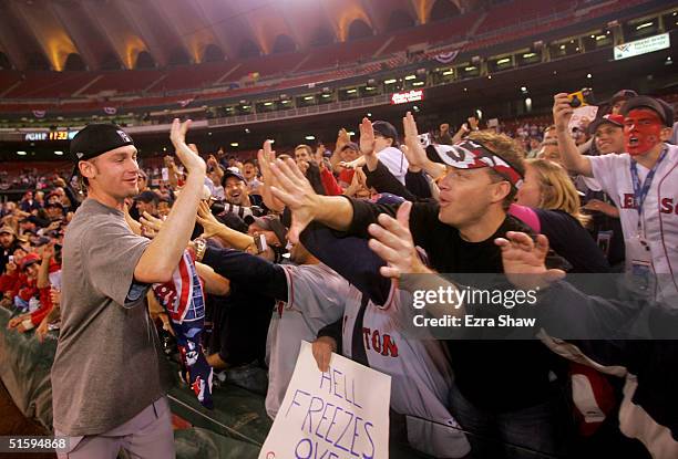 Bronson Arroyo of the Boston Red Sox celebrates with the fans after defeating the St. Louis Cardinals 3-0 in game four of the World Series on October...