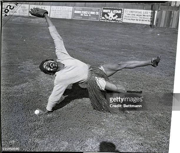 Player on the African Clowns, a black minor league baseball team, wears a grass skirt and face makeup instead of a regulation uniform as he clowns on...