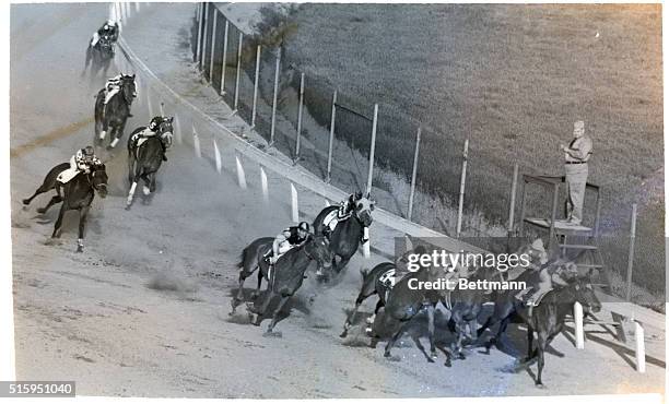 Lexington, Kentucky: Taking the turn for the finish line, jockey Eddie Arcaro, astride Whirlaway , fourth from the rail, makes the bid that gave is...