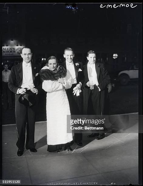 Hollywood, California: Douglas Fairbanks, Jr., with Mrs. Fairbanks, Joan Crawford and friends arriving at the opening night performance of his new...
