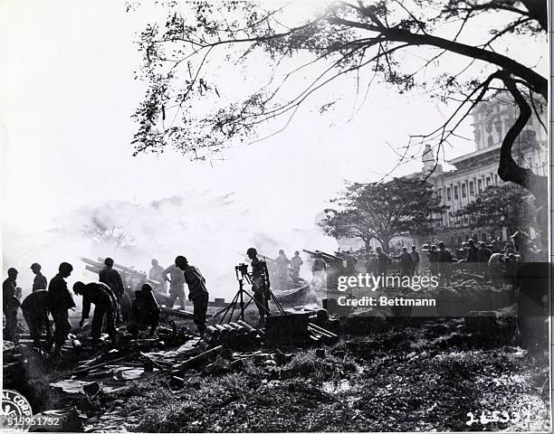 Manila, Philippines: On February 5, 1945 these four 105-MM Howitzers of the 61st Field Artillery Battalion, U. S. Army were blasting the Japanese out...