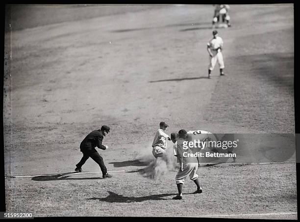 New York, NY: Third baseman Jorgensen of the Dodgers slides safely into third base on Gregg's infield grounder in the second inning at Yankee...