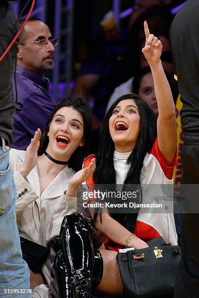 Kendall Jenner and sister Kylie Jenner attend Los Angeles Lakers and Sacramento Kings basketball game at Staples Center March 15 in Los Angeles,...