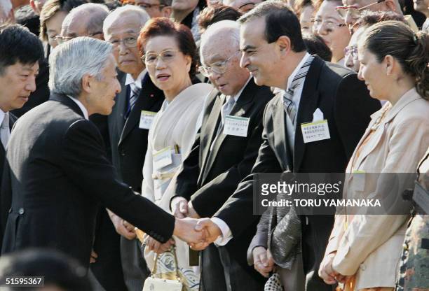 Carlos Ghosn , president of Japan's auto giant Nissan Motor, and his wife Rita are welcomed by Japanese Emperor Akihito during the annual autumn...