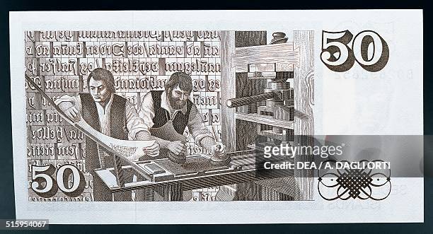 Kronur banknote reverse, printers at work on a printing press in 16th century. Iceland, 20th century.