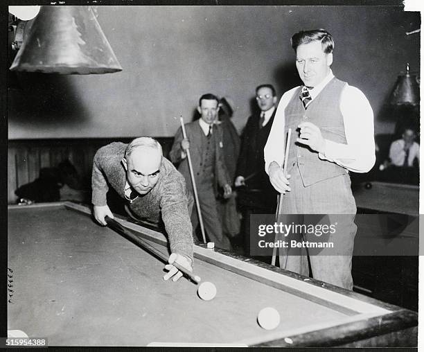 Germantown, PA: "Bing" Miller, Boston American outfielder, and Rube Walberg, Boston American pitcher, , exchange bats for billiard cues at the...