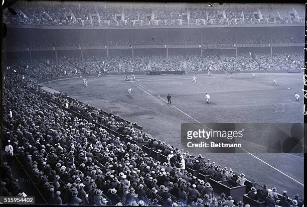 Photo shows Waite Hoyt about to deliver the ball to Rogers Hornsby while Lou Gehrig looms off first base in the deciding World Series game. The...