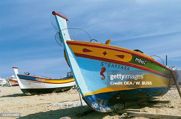 Fishing boats docked on the beach, Armacao de Pera, Algarve, Portugal.