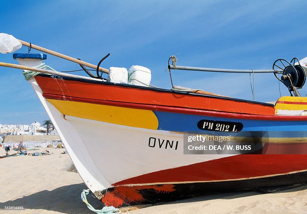 Painted bow of fishing boat docked on beach