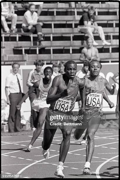 Helsinki, Finland- American sprinter Carl Lewis takes off with the baton from teammate Calvin Smith, during qualification heat of the 4 X 100m relay...
