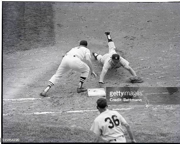 Washington, D.C.- New York Yankees center-fielder Mickey Mantle dives safely back to first base here 8/12 in the fourth inning. Washington Senators'...
