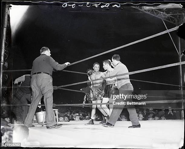 New York, NY- Henry Armstrong aids vanquished champion Barney Ross to his corner after handing him a fifteen round lacing to cop his welterweight...