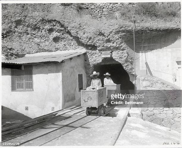 San Luis Potosi in the San Pedro Hill Gold Mine of the San Pedro Mine Company. An ore shaft with two trams of fresh ore coming out. Undated.