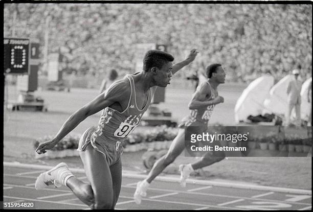 Los Angeles, CA - First raised in the air, Carl Lewis, American Athelete, flashes across the finish line, winning the men's 200m dash in 19.8...