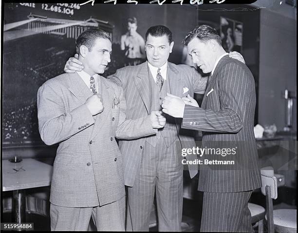 New York, NY- Jack Dempsey, center, former world's heavyweight champ, wishes both Melio Bettina, of Beacon, NY, l, light-heavyweight champ, and Italo...