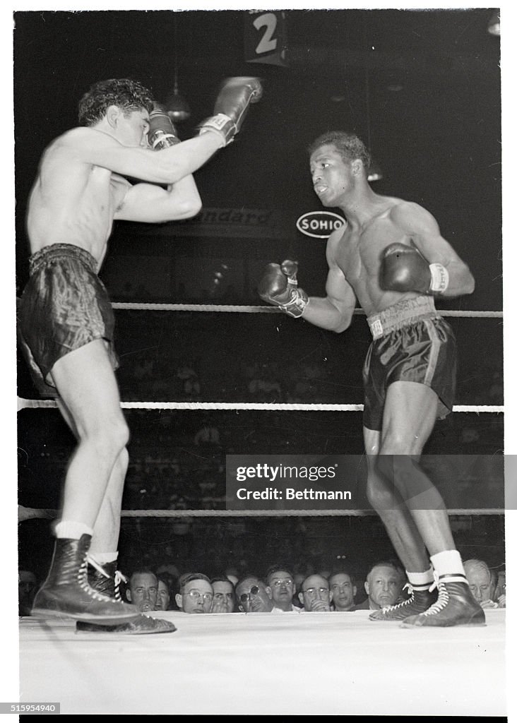 Cleveland, Ohio- Sugar Ray Robinson stalks his foe, Jimmy Doyle of