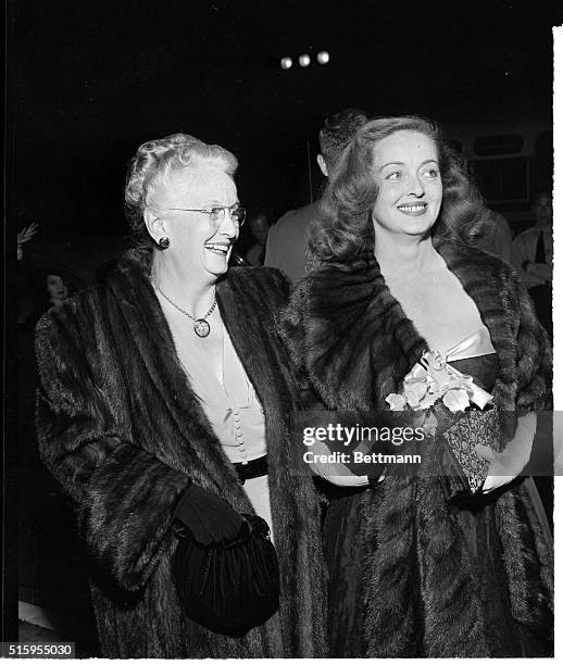 Hollywood, California-Star of the movie, Bette Davis, arrives at the premiere for "All About Eve" with her mother, Mrs. Ruth Davis Budd. Bette wears...