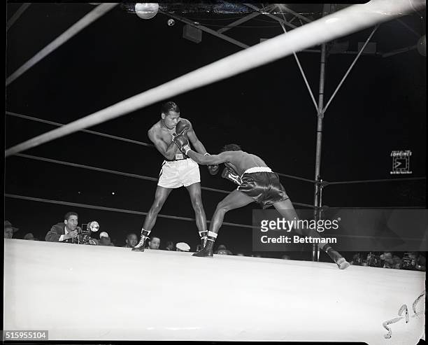 New York, NY- Welterweight champion Ray Robinson of New York blocks a left thrown by Kid Gavilan of Cuba during their ten-round, non-title match at...