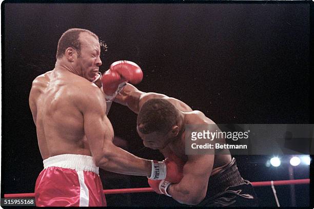 Las Vegas, NVJames "Bonecrusher" Smith digs a right hand to stomach of WBA champion Mike Tyson but gets a hard right to the head in return in the...