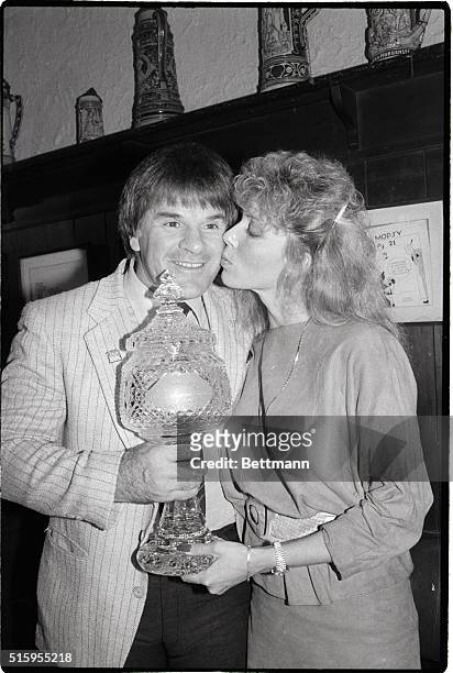 Pete Rose, player/manager of the Cincinnati Reds, accepts a $15,000 Waterford crystal trophy, as The Sporting News 1985 Man of the Year, for breaking...