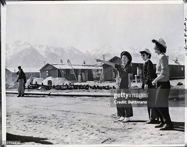 Independence, California: Three Japanese girls, evacuated from coastal areas, are shown looking over their new home in America's first wartime...