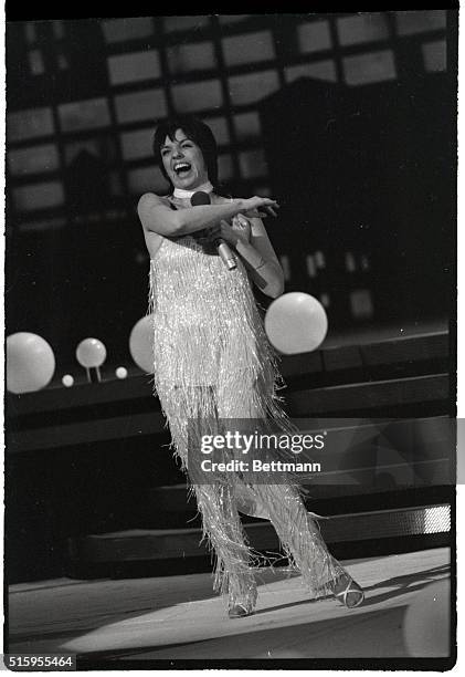 Liza Minnelli sings on stage in a sparkling fringe outfit at "Night of 100 Stars," an actors fundraising benefit at Radio City Music Hall in New York.