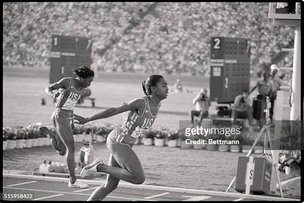 Los Angeles, CA- American runner Evelyn Ashford flashes across the finish line, winning the gold medal in the 100m race, in an Olympic record time of...