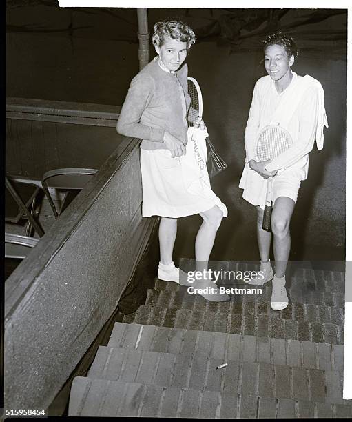 Forest Hills, NY- Louise Brough , the Wimbledon Champ, and Althea Gibson, the first Negro ever to play in the national Tennis Championships, duck...