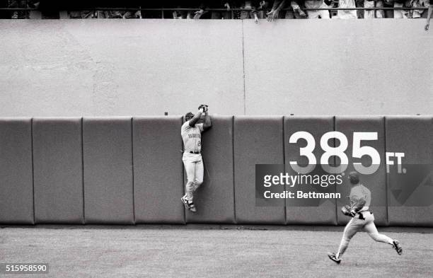 New York, NY - Seattle mariners centerfielder Ken Griffey jr. Leaps and reaches over the wall and grabs the ball robbing yankees Matt Nokes of a 2...