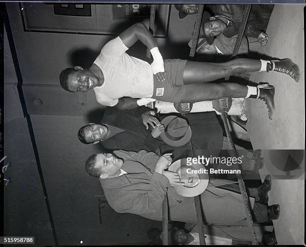 New York, NY- Former heavyweight boxing champion Joe Louis and welterweight champion Sugar Ray Robinson take outside places at the ring as...