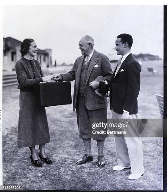 Pinehurst, NC- Miss Lillian Ross of Little Compton, RI, receives first prize from her dad, Donald J. Ross, who is a well-known golf course architect,...