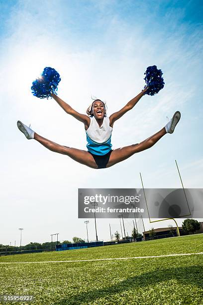 cheerleader split leap - black cheerleaders stock pictures, royalty-free photos & images