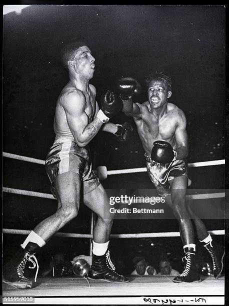 London, England- Randolph Turpin, left, sways back from a right swung by Sugar Ray Robinson during their title bout at Earl's Court, London, July 10....