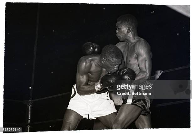 New York, NY- With head lowered, Jimmy Carter moves in for some close-target, can't-miss leather work to defending lightweight champ Ike Williams'...