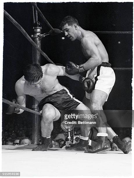 New York, NY- Roland La Starza goes down on the ropes under a beating from Rocky Marciano during the fifth round of their ten-round bout at Madison...