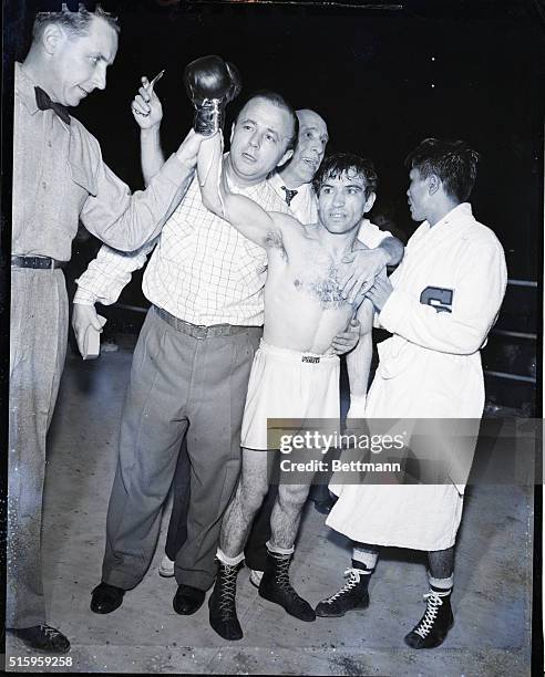 Tokyo, Japan- Pascual Perez of Argentina has his hand raised in victory after winning the world flyweight championship in an unanimous decision over...